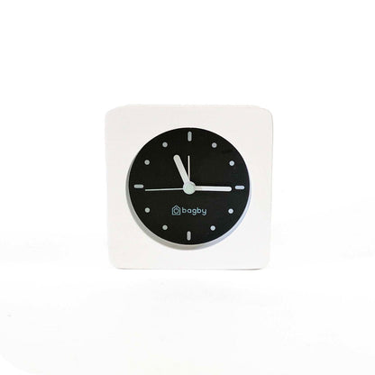 Bagby MINIMALIST alarm clock with backlight activated showing illuminated face in dark room