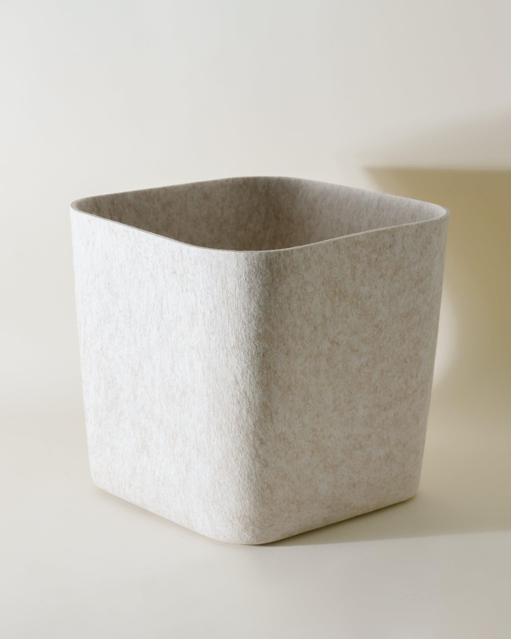 Four Sculpted Bins nested inside each other demonstrating space-saving storage when empty