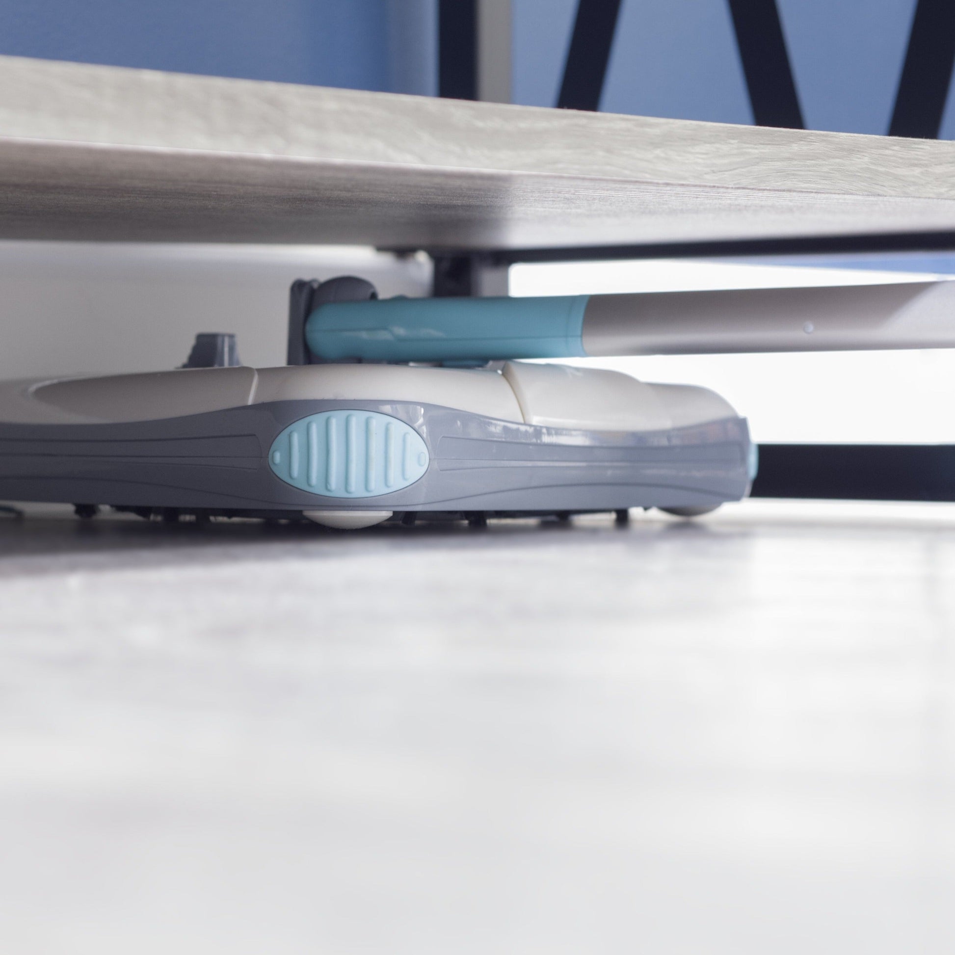 Person using Zippi Sweeper on hardwood floor demonstrating lightweight operation